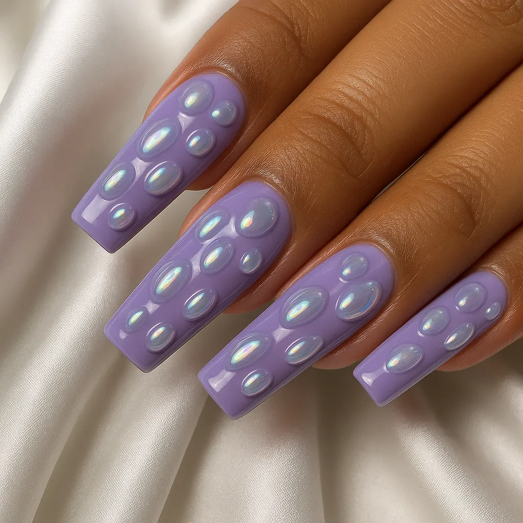 Long coffin nails in glossy lavender covered in raised iridescent aurora chrome blobs, on warm tan skin over white satin.